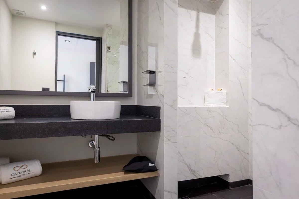 Hotel Catedral. Interior single room bathroom. Full marble bathroom with luxury shower.