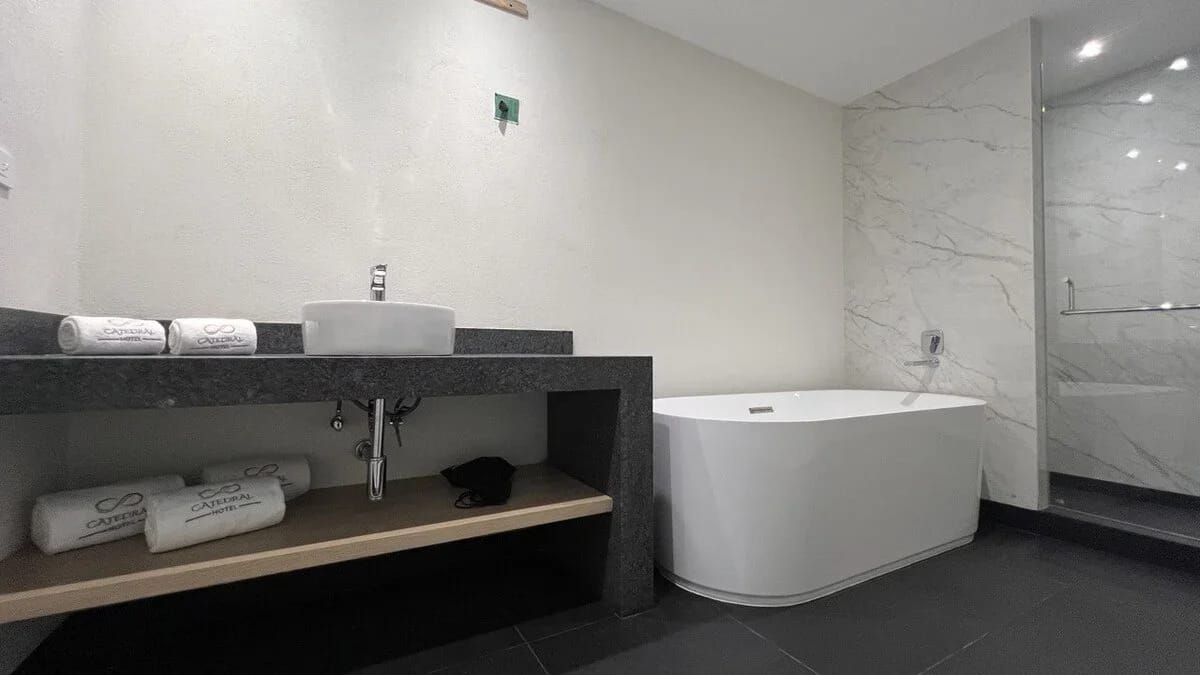 Hotel Catedral. Baño de la Corner Suite. Ducha de lujo y bañera profunda.
